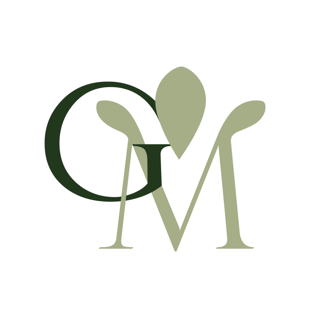 Logo featuring the letters "G" and "M" with a green leaf design incorporated between them on a white background.